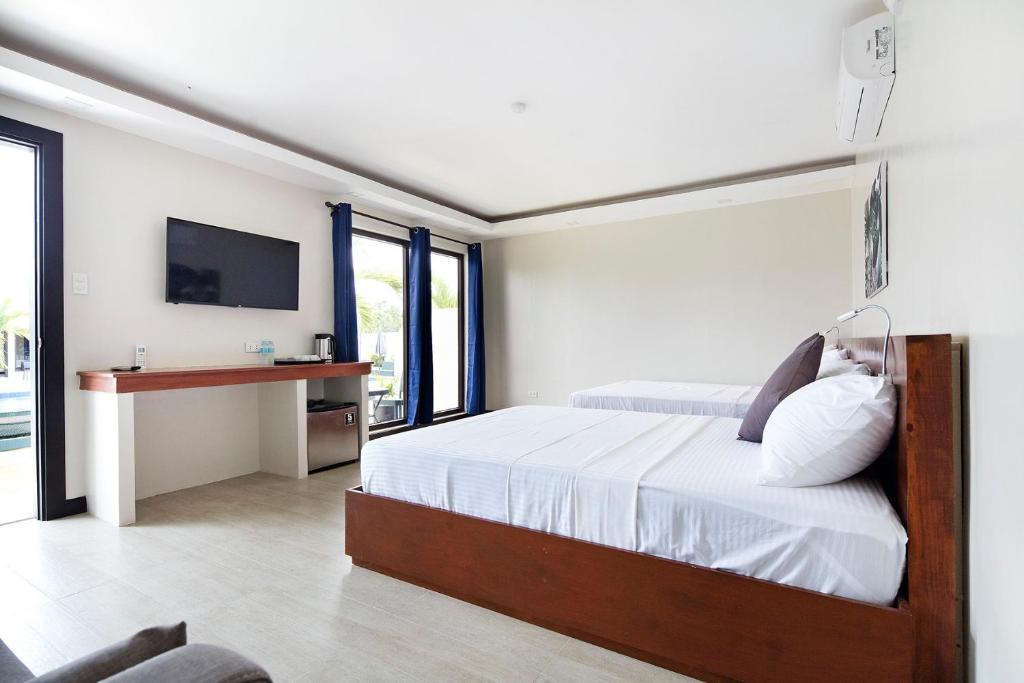 Postel nebo postele na pokoji v ubytování OHANA, Panglao Resort.