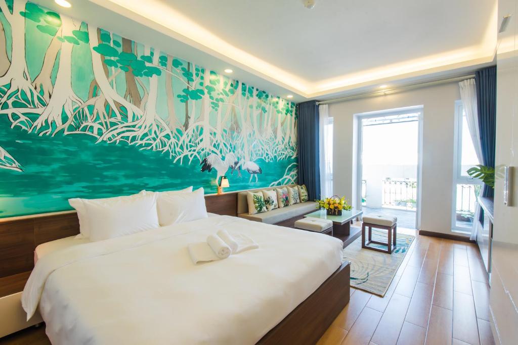a bedroom with a large bed with a large painting on the wall at Nexy Living in Hanoi