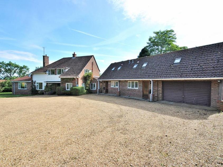 a large house with a garage and a driveway at House On The Hill in Little Massingham