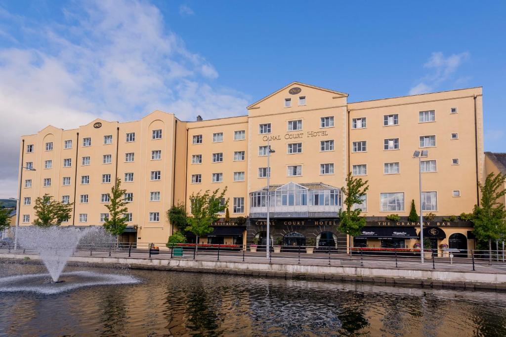 a large building next to a body of water at Canal Court in Newry