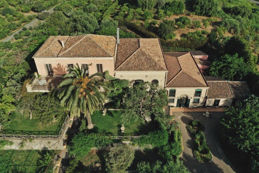 an aerial view of a house with a palm tree at Antico Borgo Etneo Agriturismo in Calatabiano
