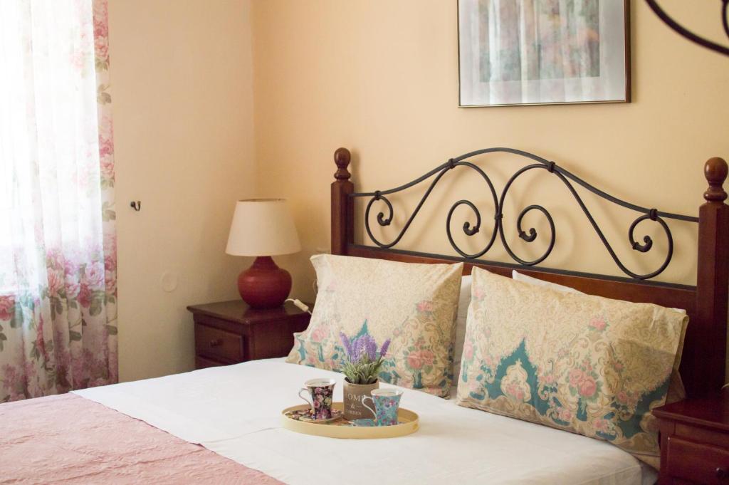 Schlafzimmer mit einem Bett mit einem Kopfteil aus Holz in der Unterkunft Elizabeth's Place in Iraklio