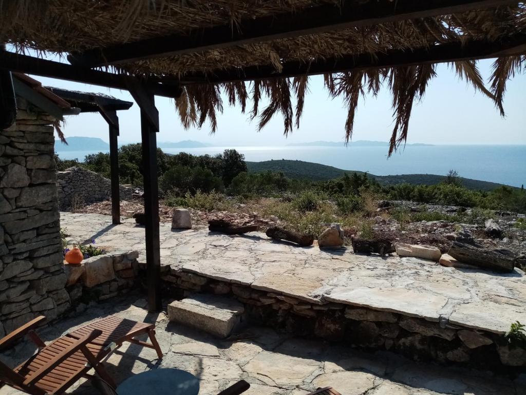 a stone patio with a view of the ocean at Pirate's Nest Stone House in Korčula