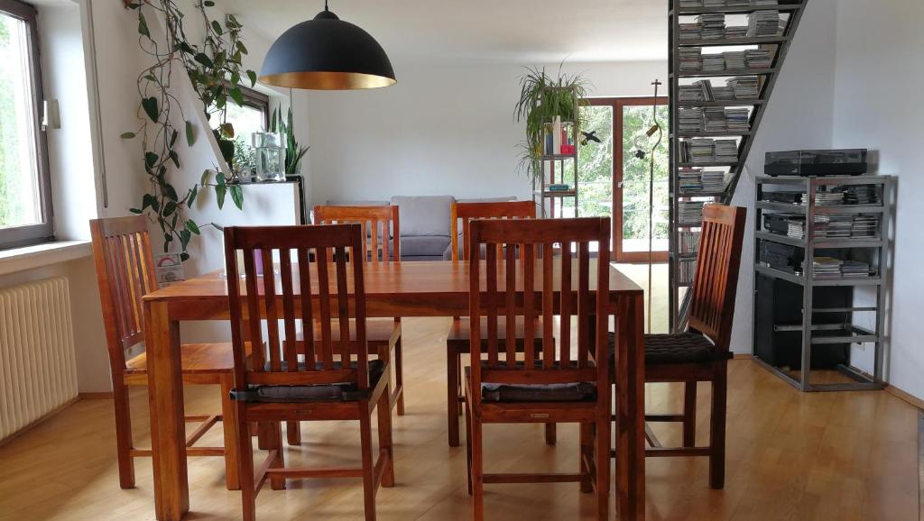 a dining room with a wooden table and chairs at Lichtblick in Vollmersbach