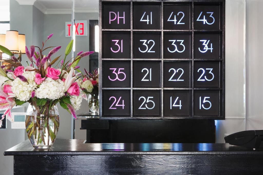 a vase of flowers on a table with a calendar at The Broome in New York
