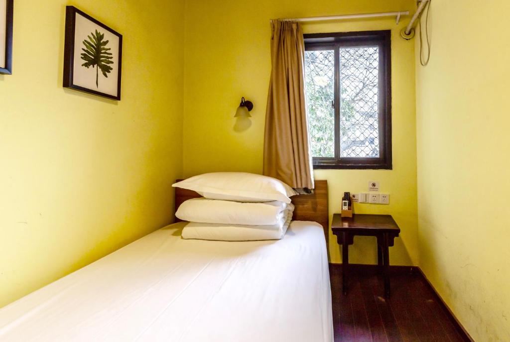 Postel nebo postele na pokoji v ubytování Hofang Guest House