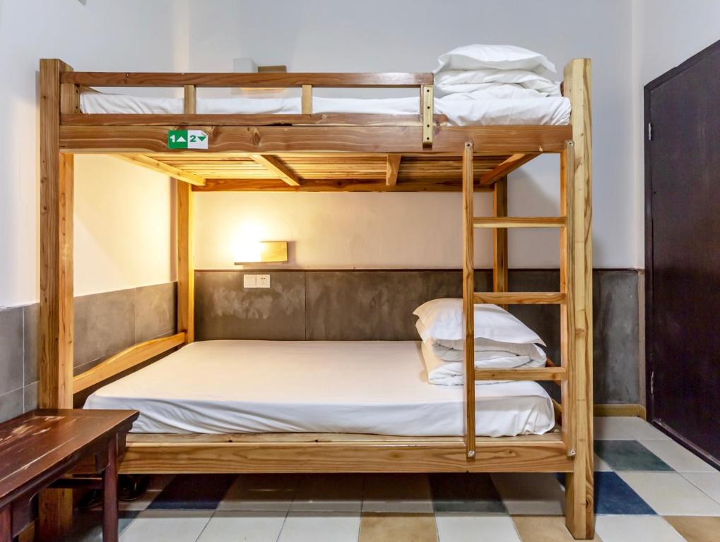 Postel nebo postele na pokoji v ubytování Hofang Guest House