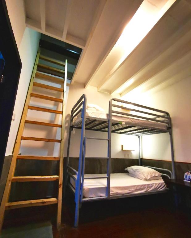 Postel nebo postele na pokoji v ubytování Hofang Guest House