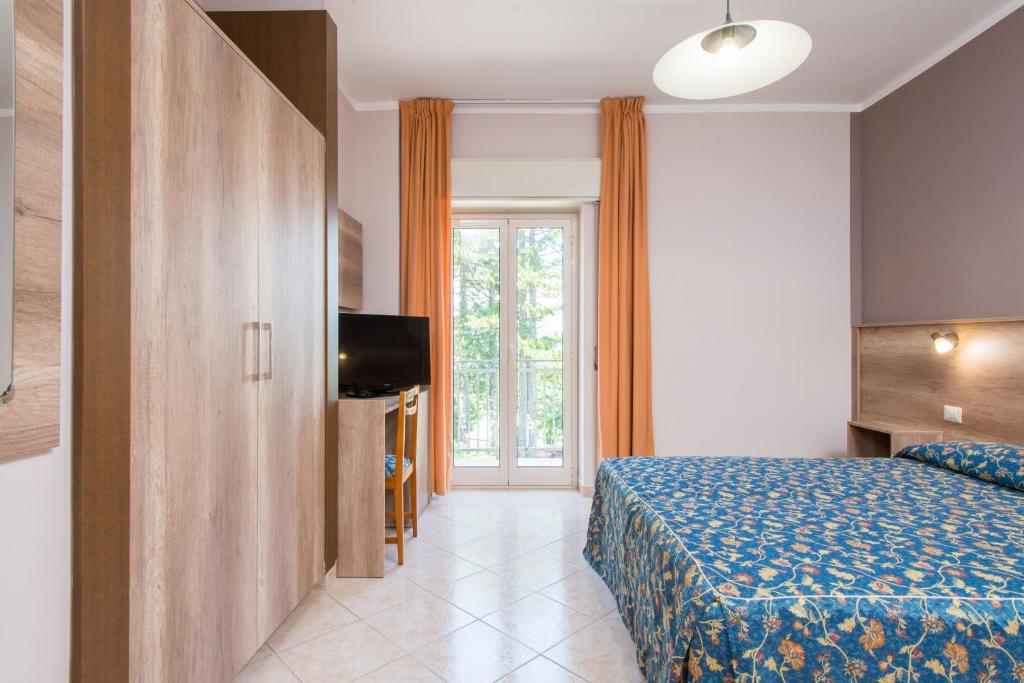 Postel nebo postele na pokoji v ubytování Hotel Tasso