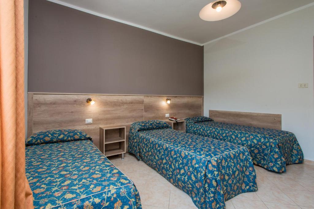 Postel nebo postele na pokoji v ubytování Hotel Tasso