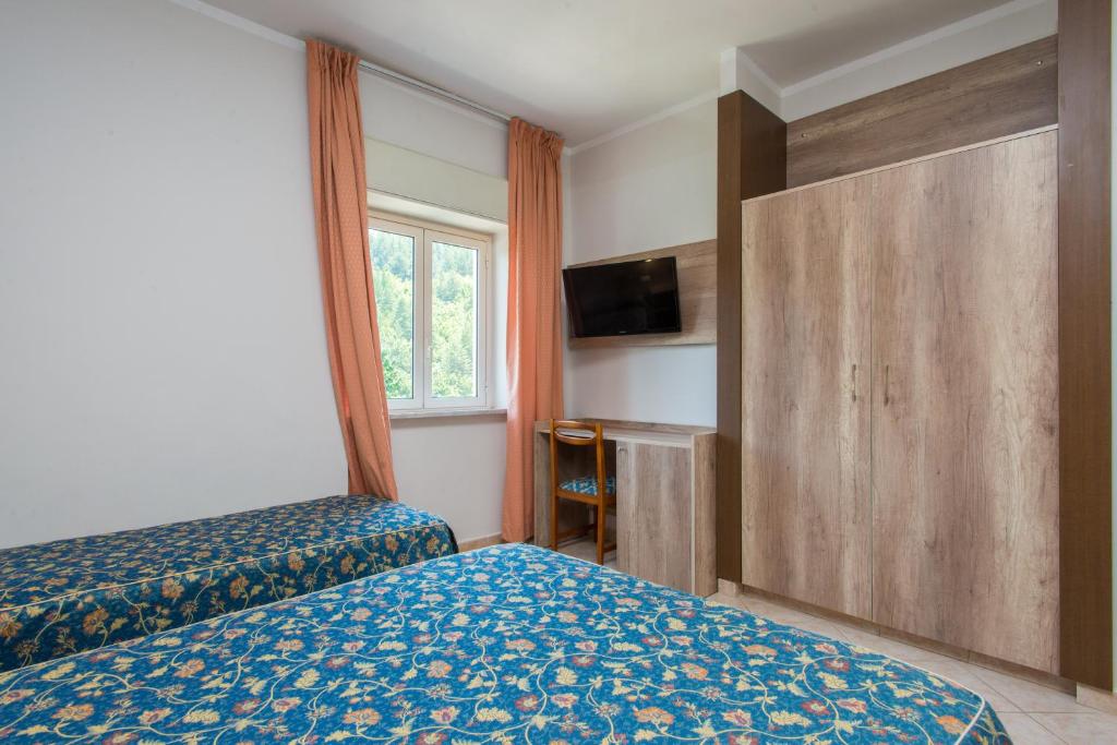 Postel nebo postele na pokoji v ubytování Hotel Tasso