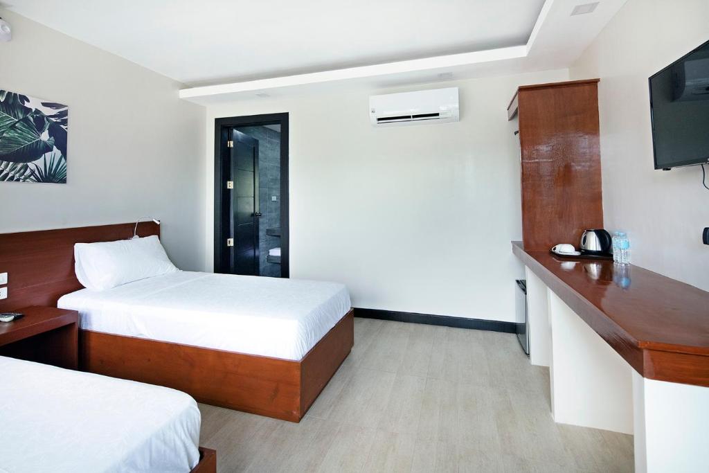 Postel nebo postele na pokoji v ubytování OHANA, Panglao Resort.