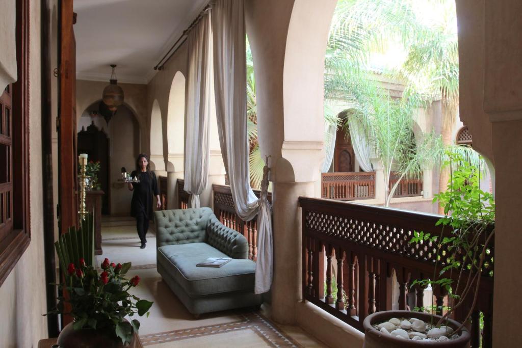 a man walking down a hallway in a house at La Villa Nomade in Marrakech
