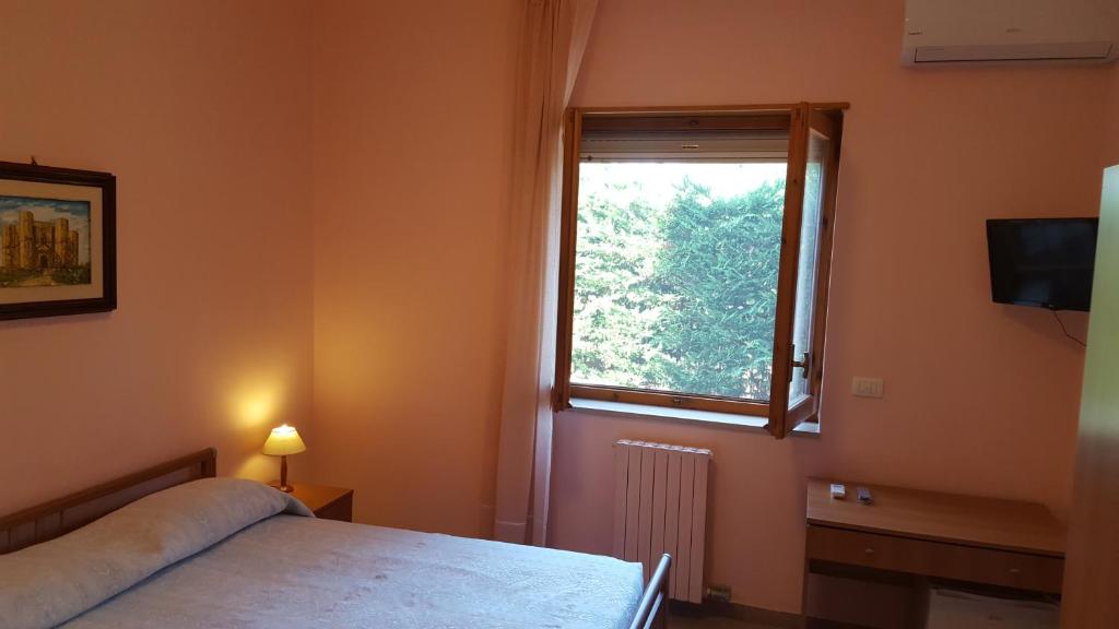 een slaapkamer met een bed en een raam bij Villa Erry in Trani