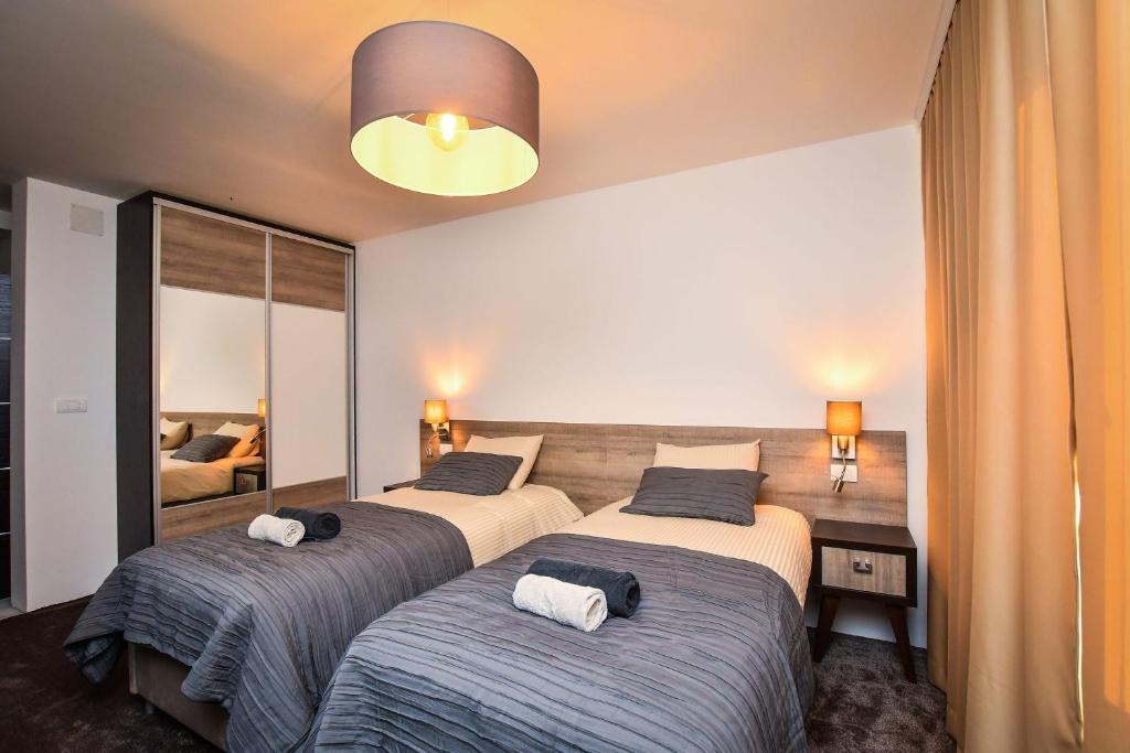 Postel nebo postele na pokoji v ubytování Miido Apartments
