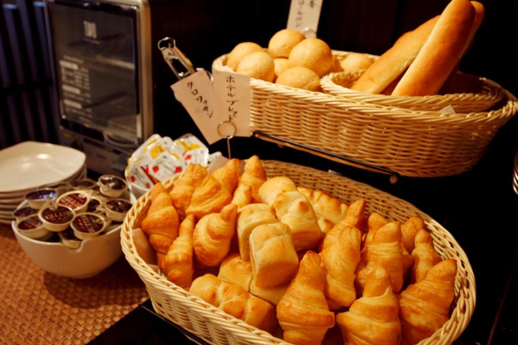 two baskets of bread and other food on a table at Takayama Ouan in Takayama