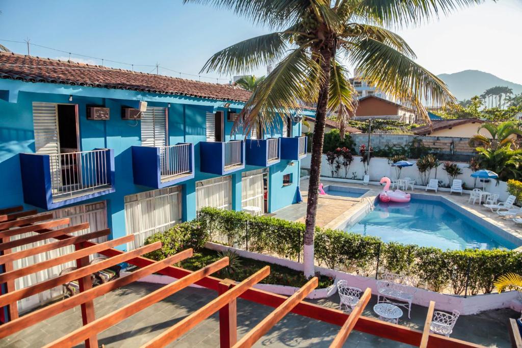 
a beach with a pool and a balcony at Hotel Costa Azul in Ubatuba
