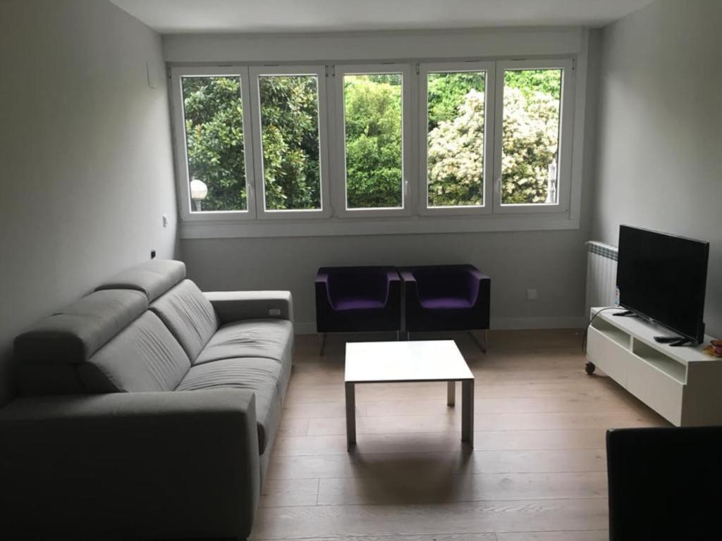 a living room with a couch and a table at Irún by Basquelidays in Irún