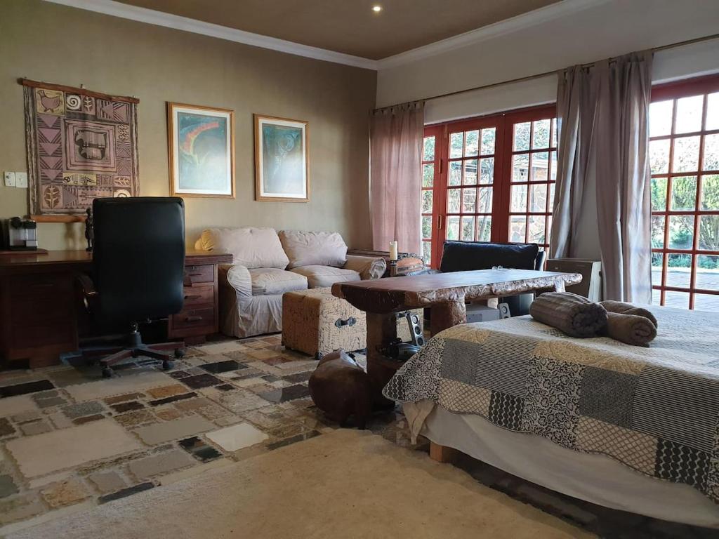 a living room with two beds and a table at Rockscape in Sandown