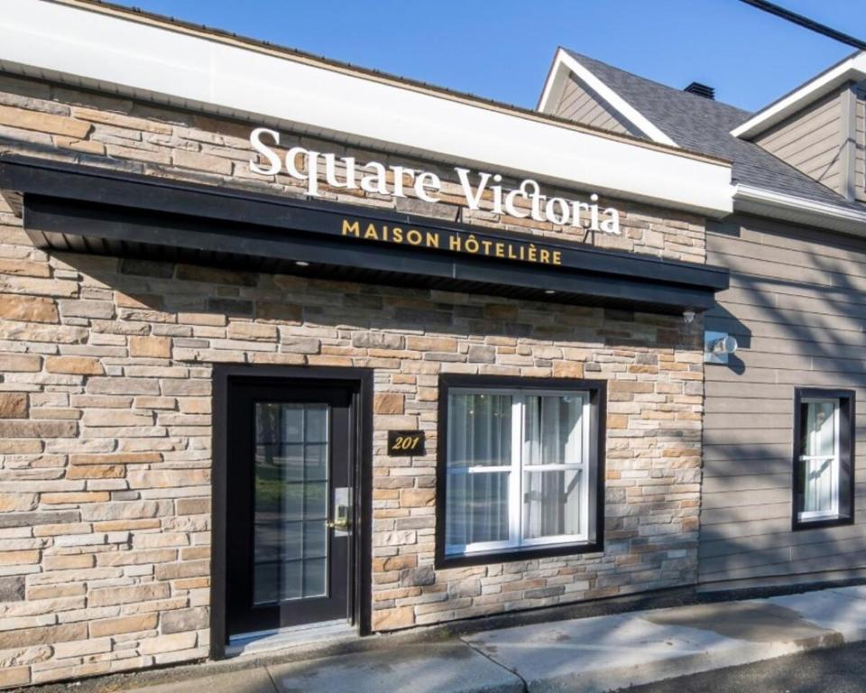 a building with a sign that reads seattle victoria malcolm hotel at Square Victoria Maison Hôtelière in East Angus