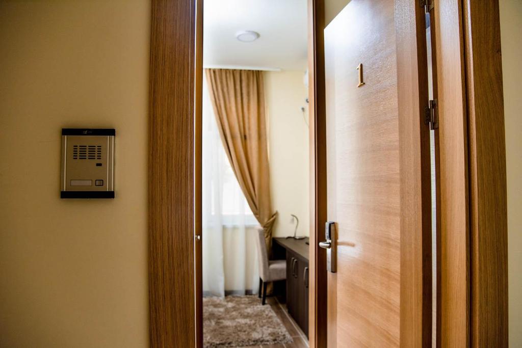 a door leading into a room with a bathroom at Santa Villa & restaurant in Sremska Mitrovica