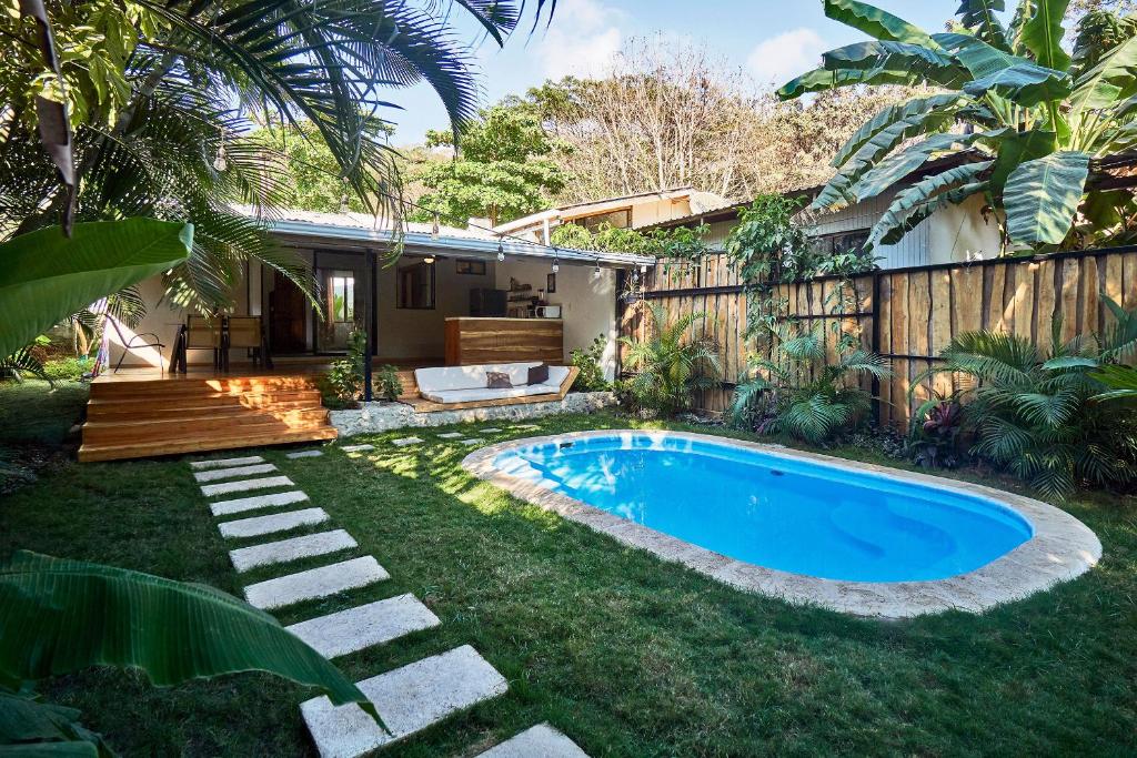 a swimming pool in the yard of a house at Villa Flamingo in Santa Teresa Beach