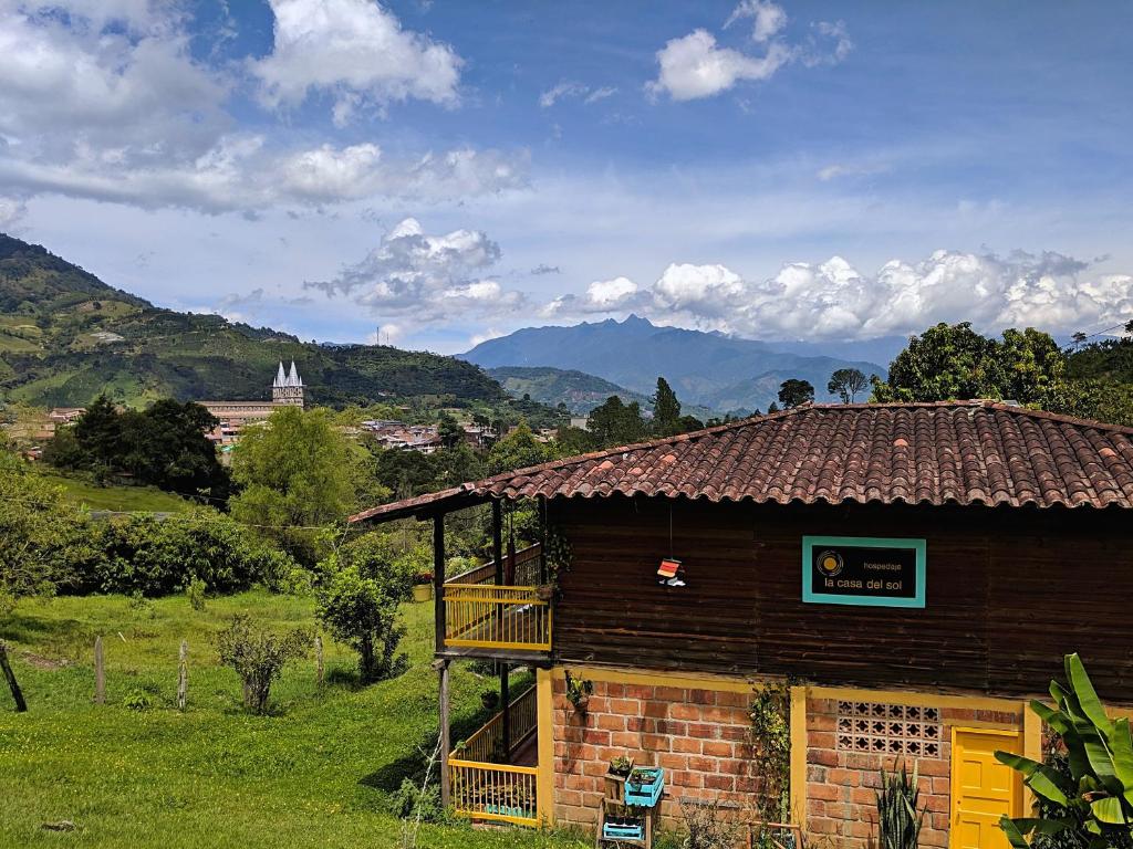 a small building in a field with mountains in the background at La Casa Del Sol in Jardin
