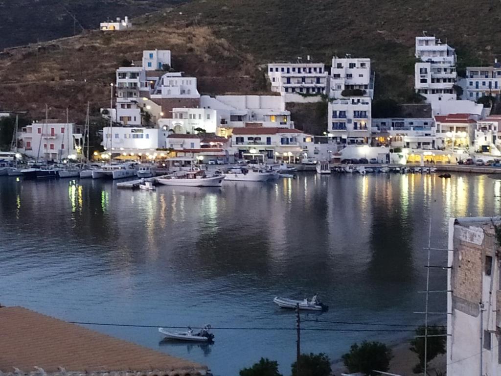 a group of buildings and boats in a harbor at Cycladic house in Kithnos