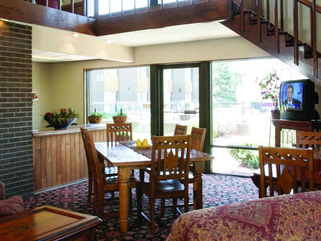 a dining room with a table and chairs at The Foothills Inn in Rapid City