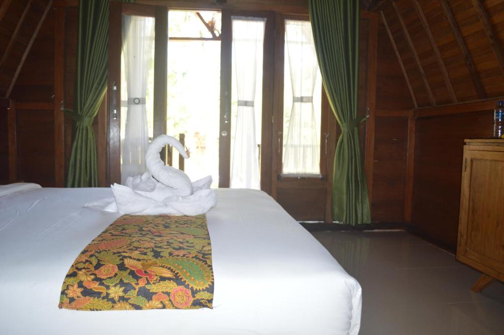 Postel nebo postele na pokoji v ubytování Nyuh Gading Bungalow Nusa Penida