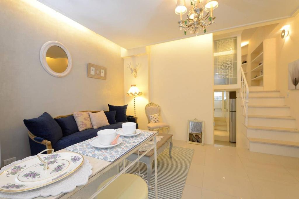a living room with a couch and a table with dishes on it at BV Taipei XinYi D in Taipei