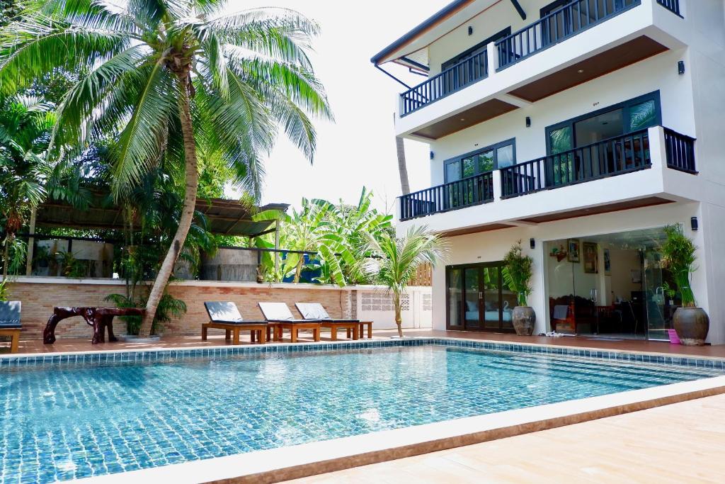 a swimming pool in front of a villa at Aiya Resort Koh-Tao in Koh Tao