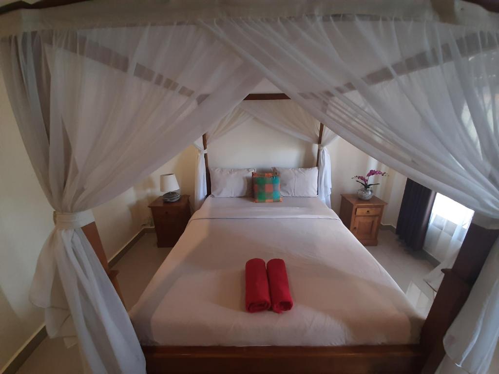 Postel nebo postele na pokoji v ubytování Pondok Wira Ubud