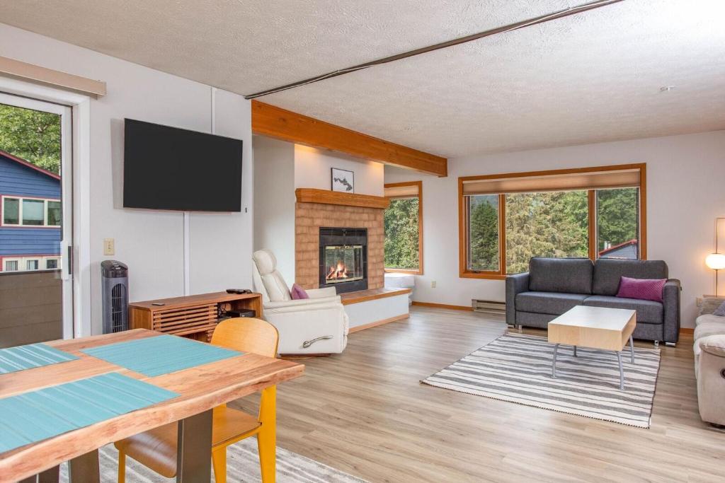 a living room with a tv and a fireplace at Timberline 208 in Girdwood