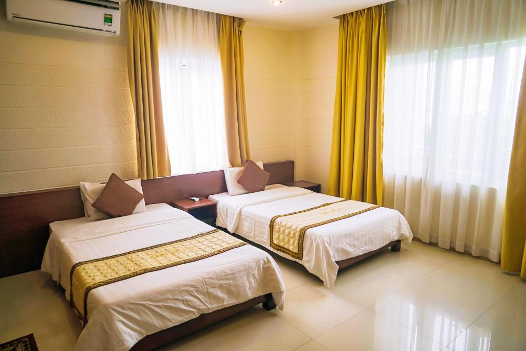 Postel nebo postele na pokoji v ubytování Dai A Hotel