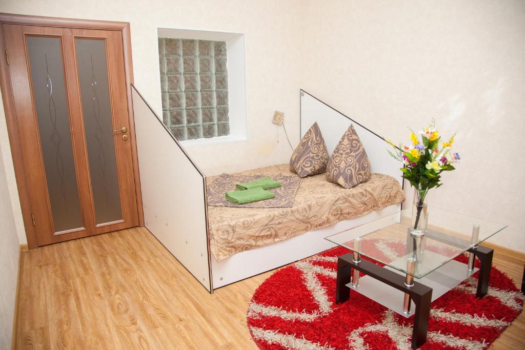 a living room with a couch and a glass table at Semi-luxury Apartment on Zhukovskogo Street 57 in Zaporozhye