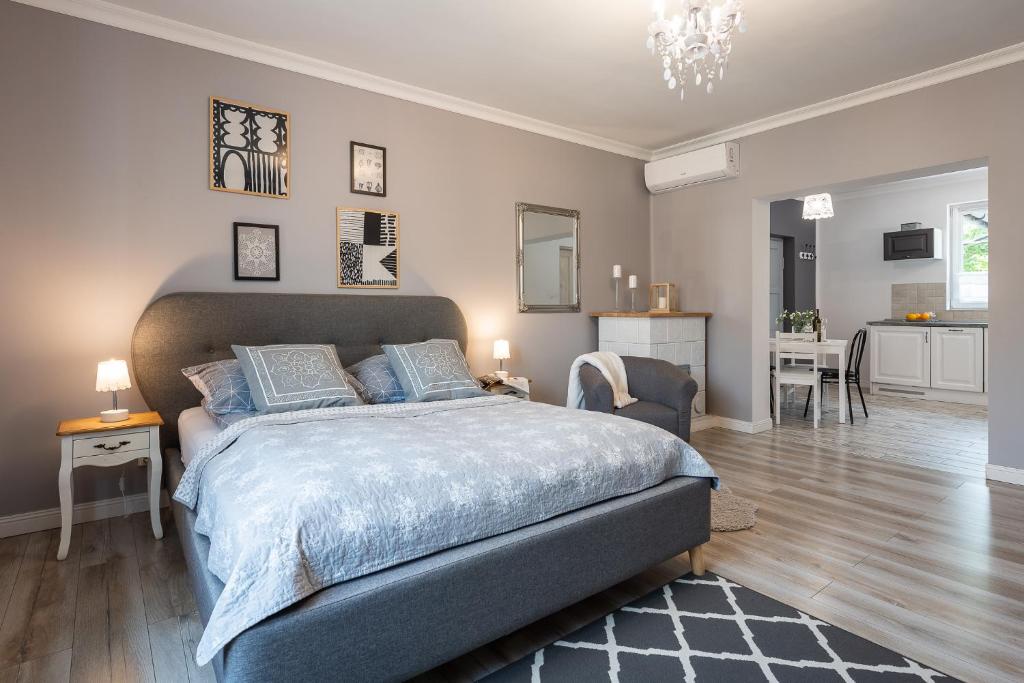 a bedroom with a large bed with blue pillows at Lu Apartments in Oświęcim