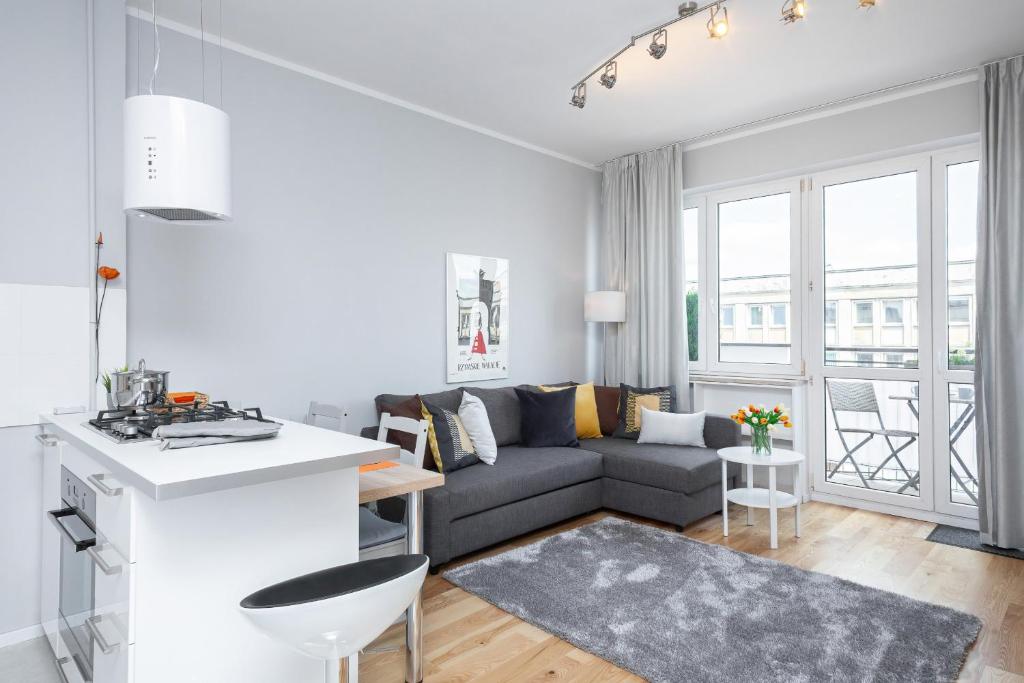 a living room with a couch and a table at Apartments City Center by Renters in Warsaw