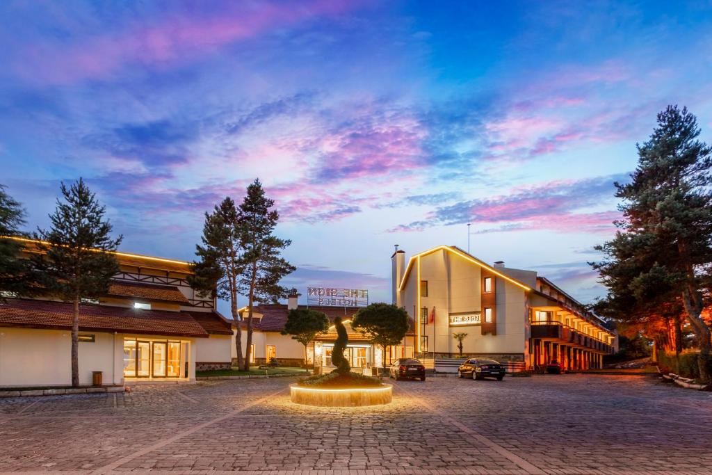 a building with a fountain in the middle of a street at The Sign Esentepe Hotel&Kayak Merkezi in Gerede