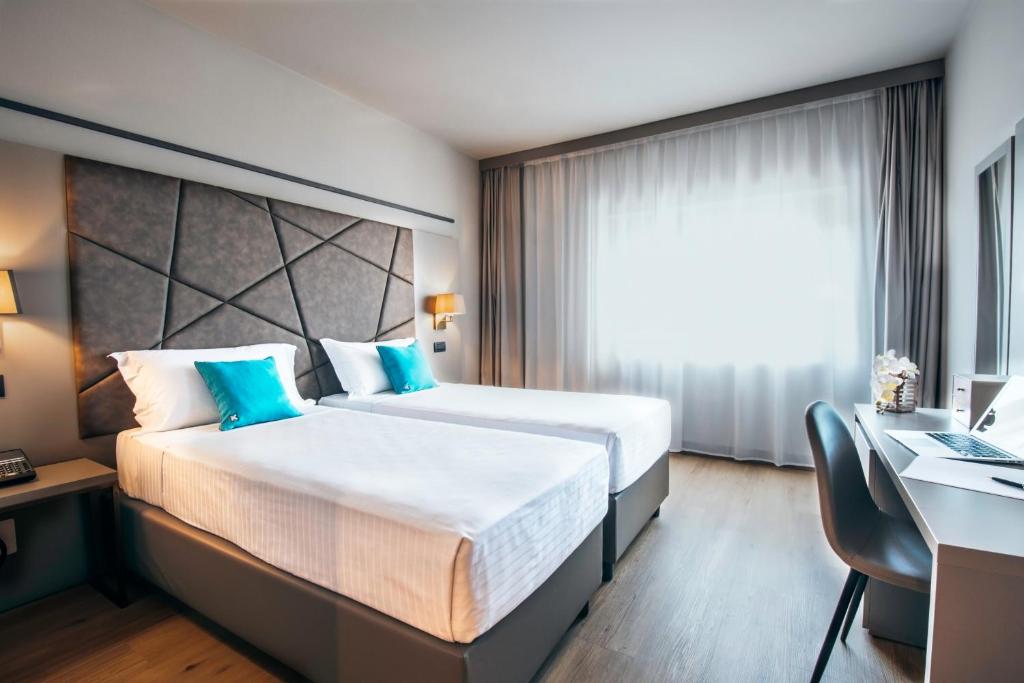 Postel nebo postele na pokoji v ubytování DC HOTEL INTERNATIONAL