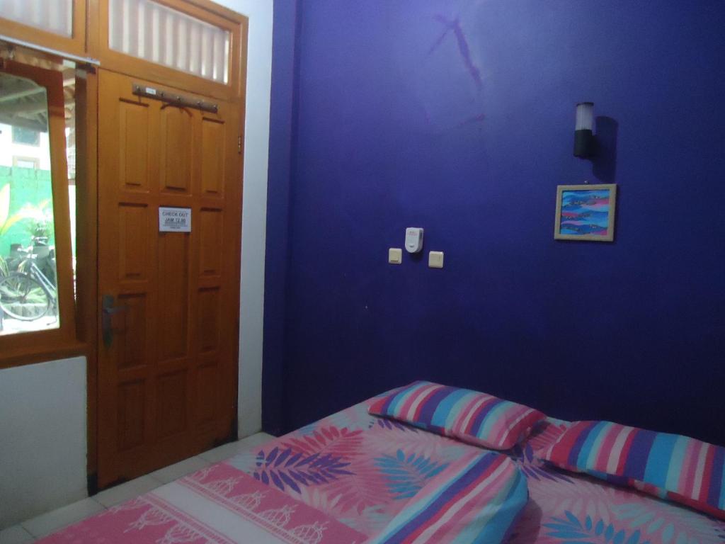 Postel nebo postele na pokoji v ubytování Kancil homestay