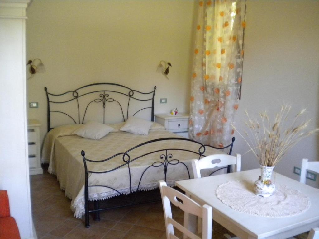 a bedroom with a bed and a table and chairs at Agriturismo Monteortone in Abano Terme