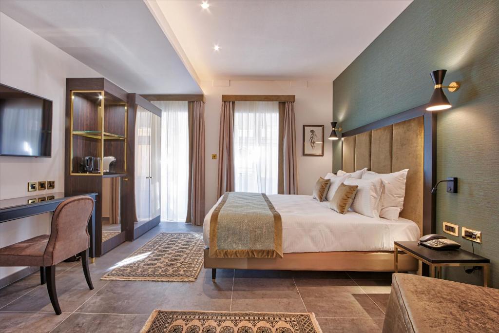 Postel nebo postele na pokoji v ubytování Palazzo Rosaria Boutique Hotel