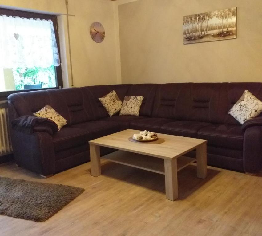 a living room with a couch and a coffee table at Ferienwohnung im Rottal in Oberrot