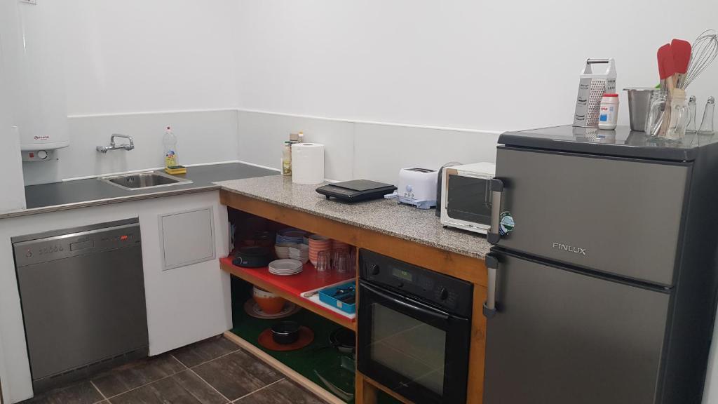 a small kitchen with a sink and a refrigerator at House bedroom in Burgas