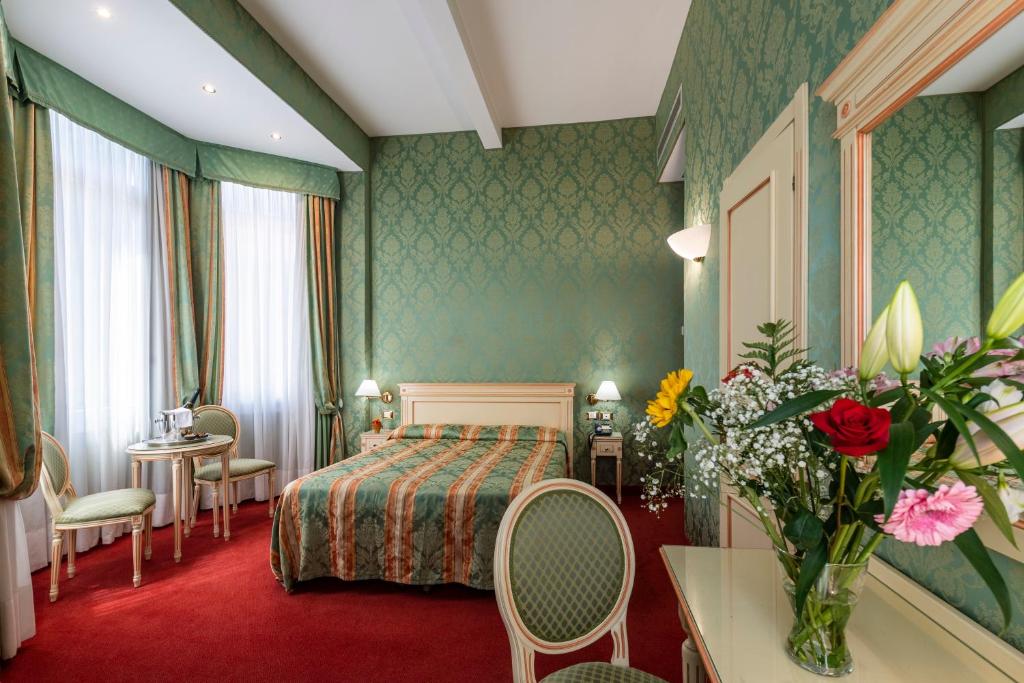 Postel nebo postele na pokoji v ubytování Hotel Villa Delle Palme