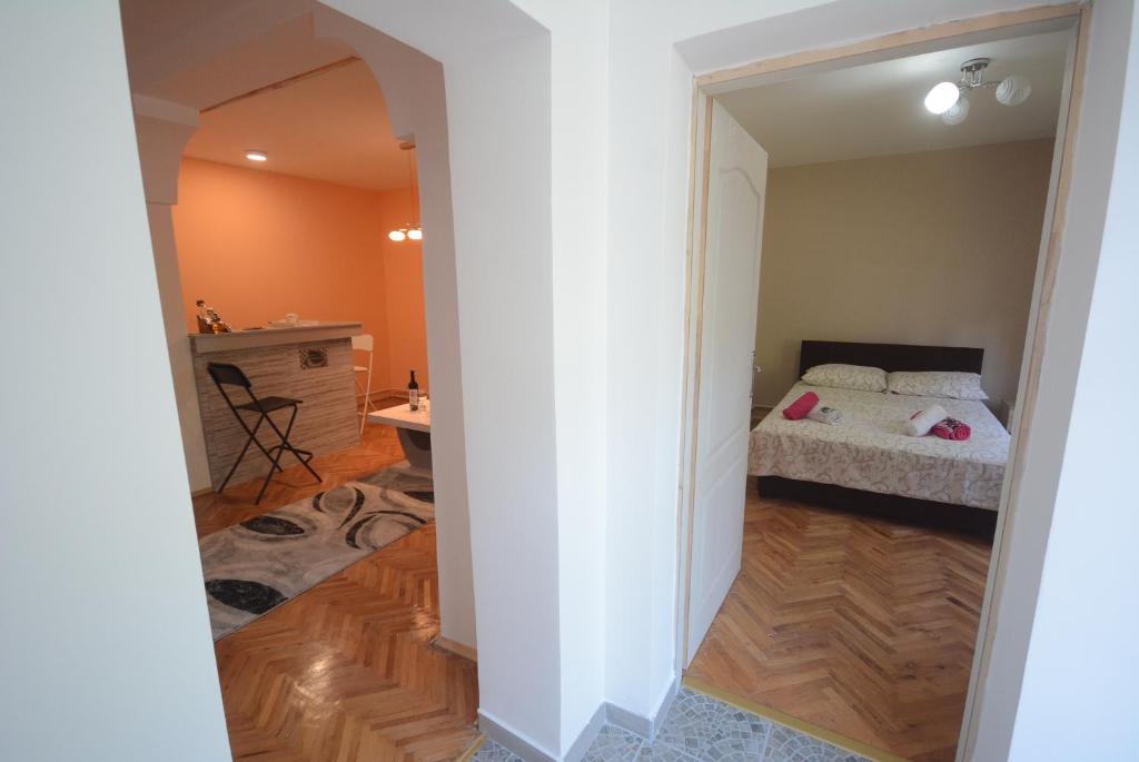 Schlafzimmer mit einem Bett, einem Tisch und einem Schreibtisch in der Unterkunft Apartmani Marić In in Vrnjačka Banja
