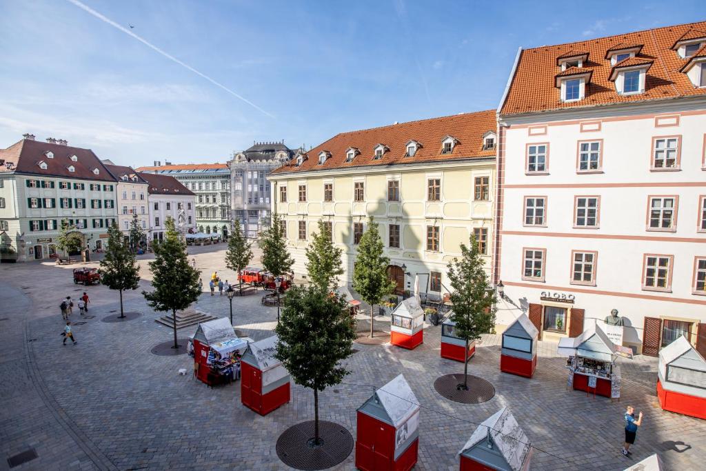 a city street with christmas trees and buildings at Best View Apartments in Bratislava