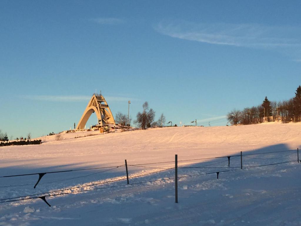 a snow covered field with a bulldozer in the background at Goski & Gobike Winterberg 4K Netflix free in Winterberg