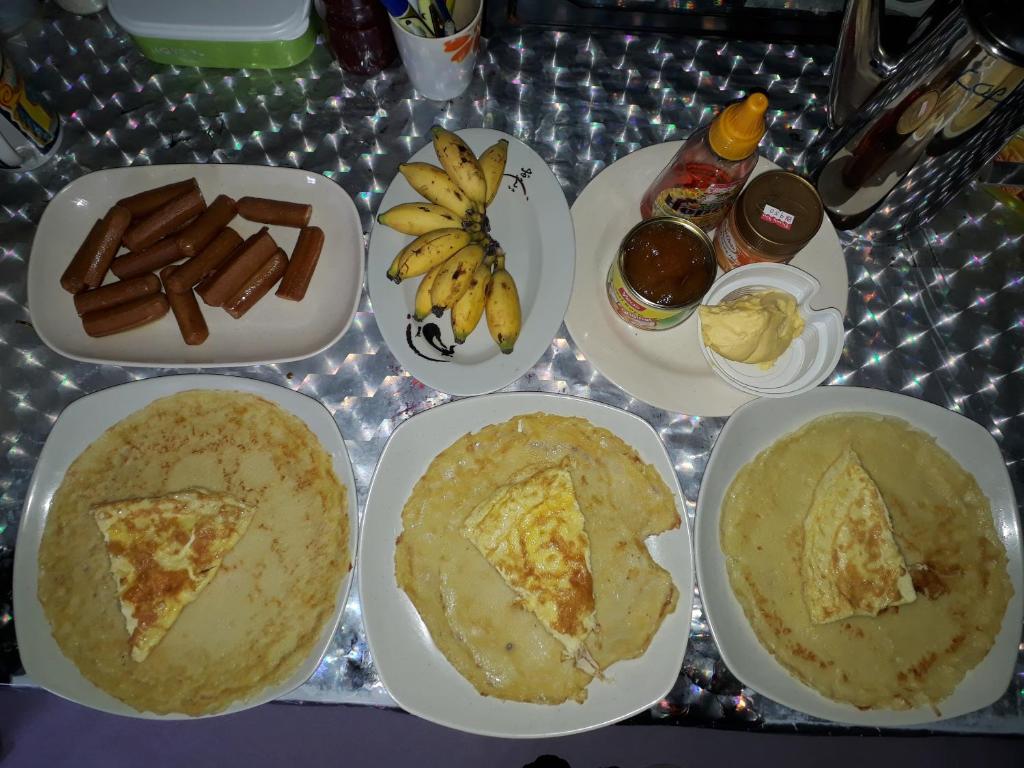 een tafel met borden met levensmiddelen en andere voedingsmiddelen bij Mulu D cave homestay in Mulu